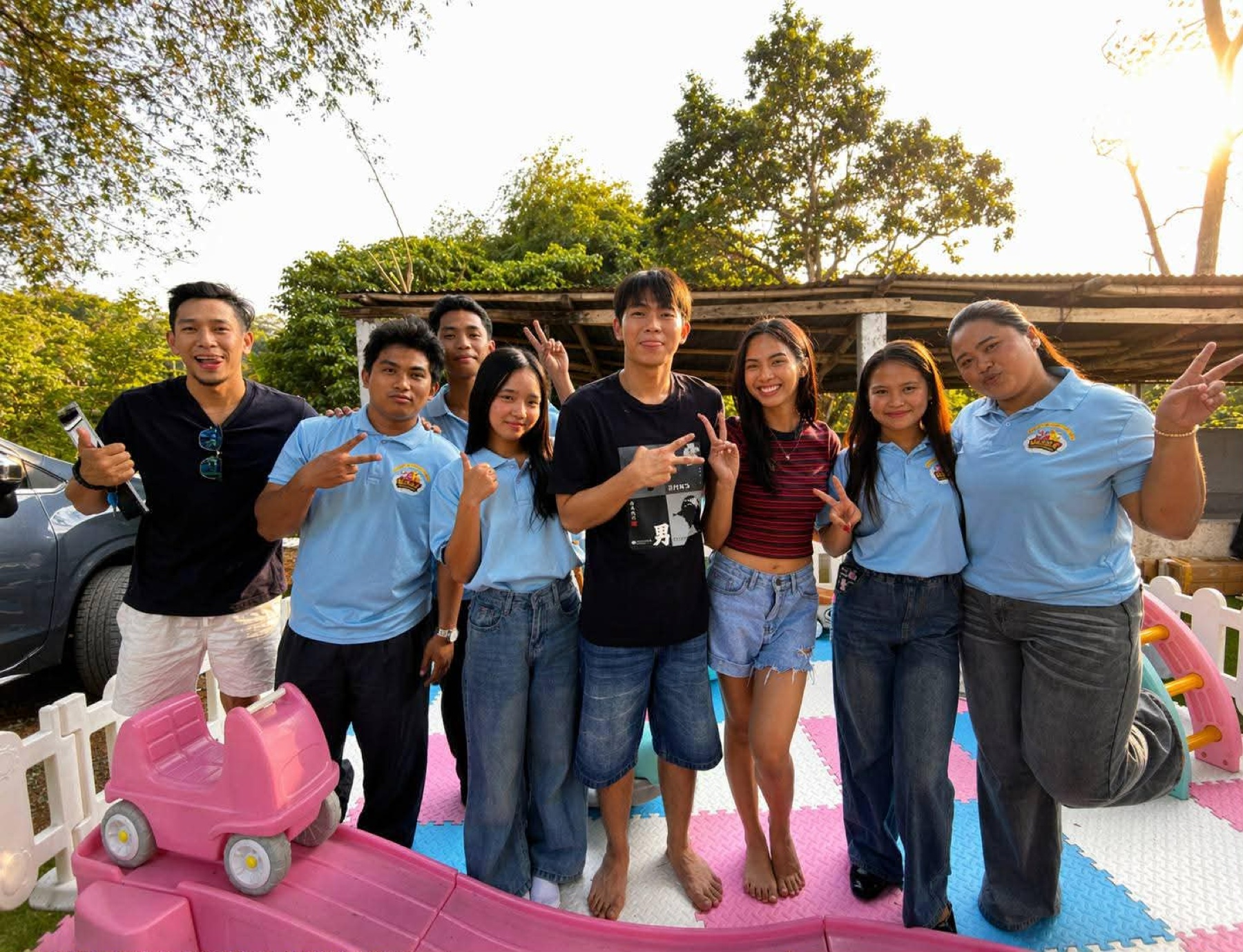 Splash & Bounce team members outdoors beside a colorful play area